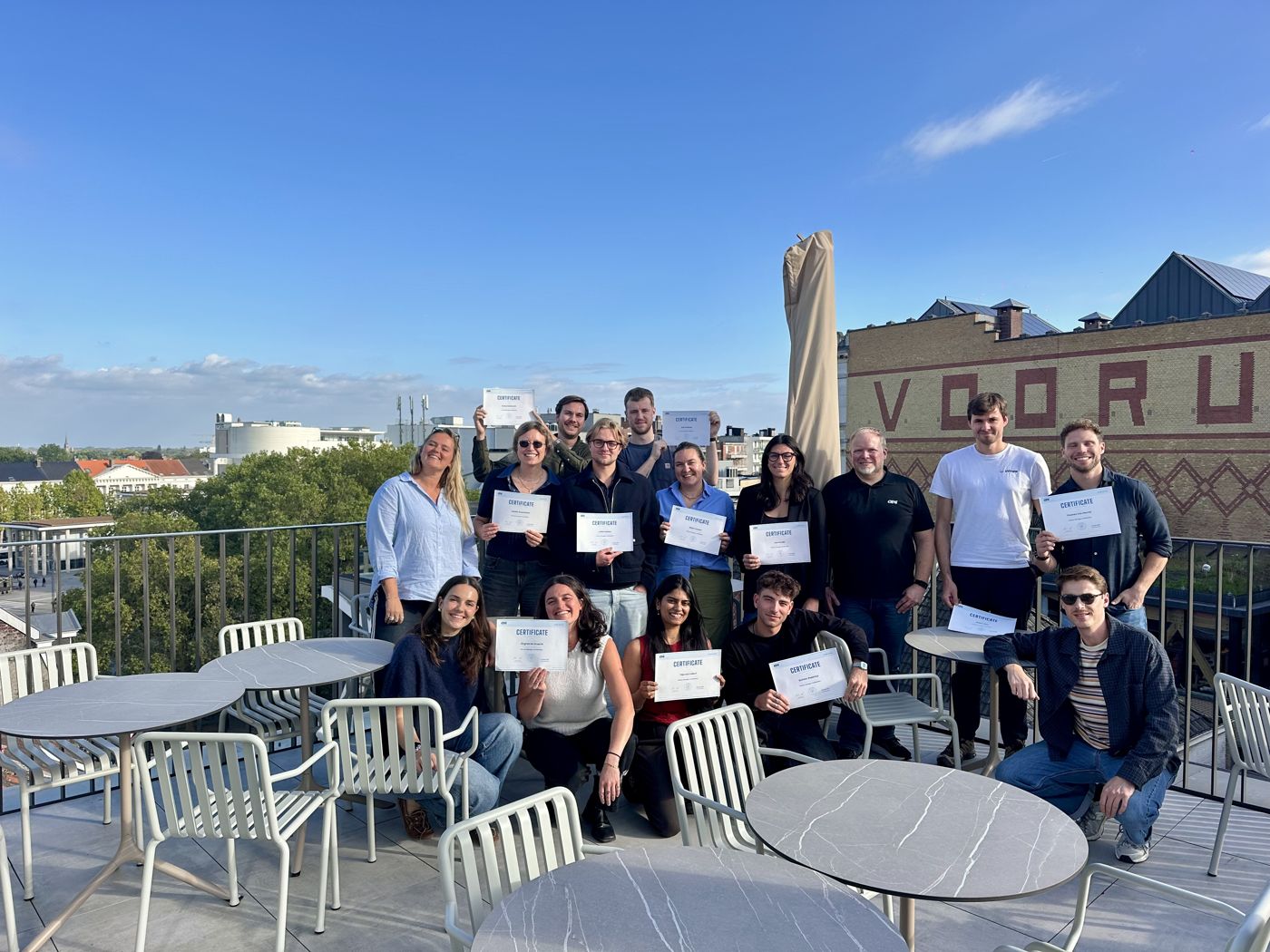 Training participants with their certificates on the rooftop of the Wintercircus